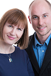 Couple stand close together in business clothes for their business card headshots in Niagara