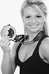Olympian poses for headshots in a black t with her silver medal in Niagara Photo Studio